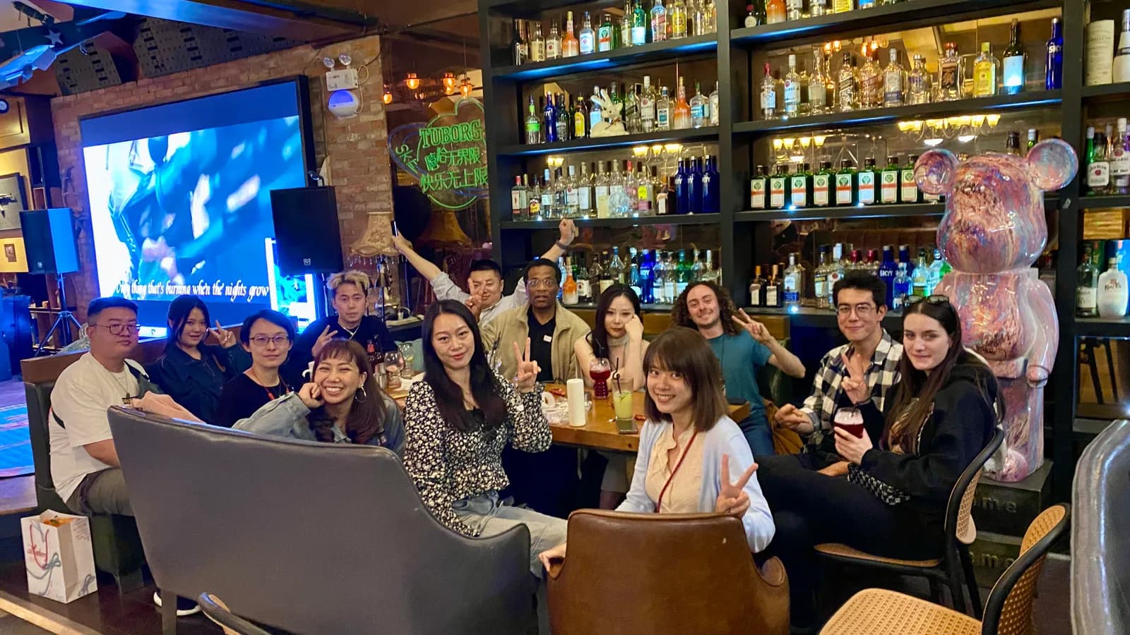 A smaller evening group around the tables at the bar